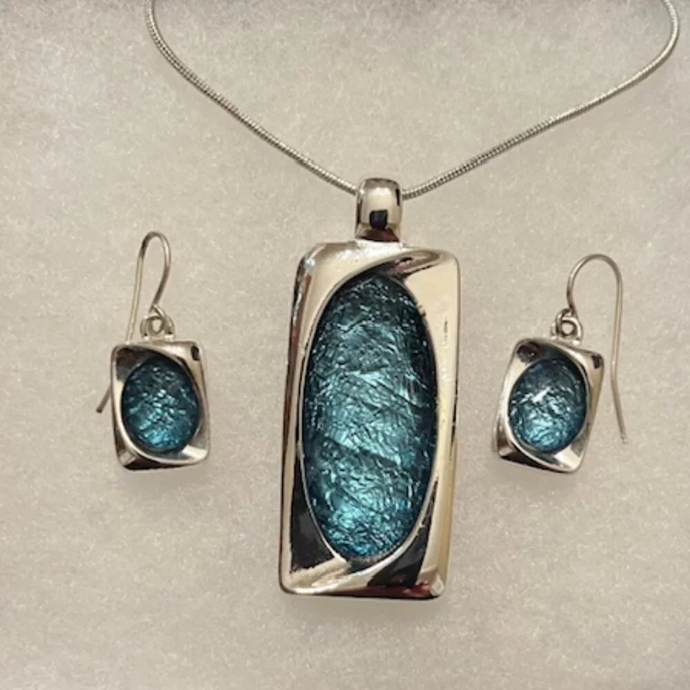 Aqua blue glass pendant and silver tone chain with matching earrings